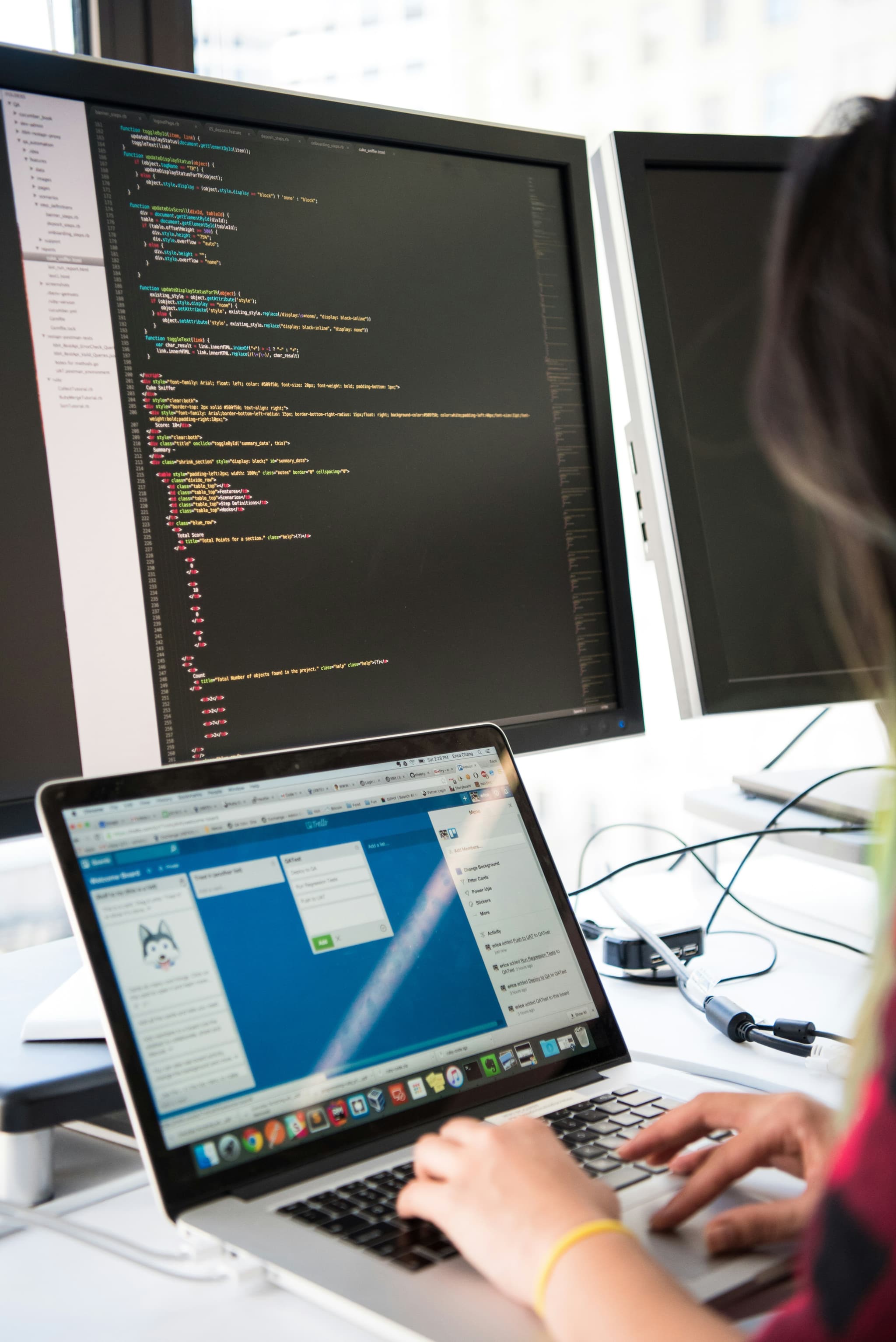 software development engineer coding across multiple screens