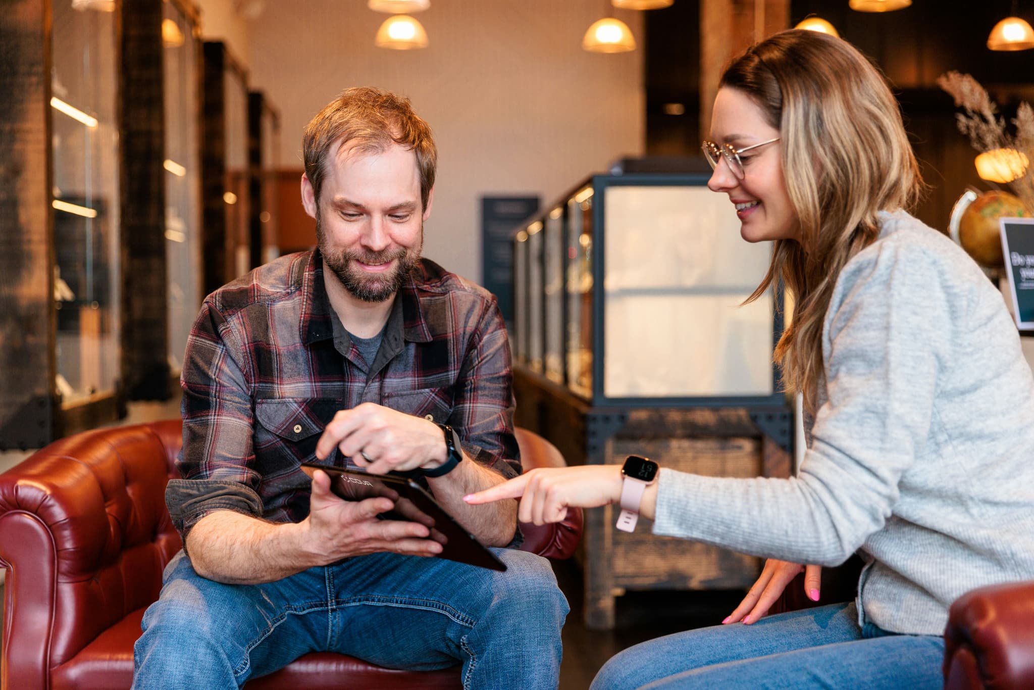workplace office two colleagues reviewing work on tablet